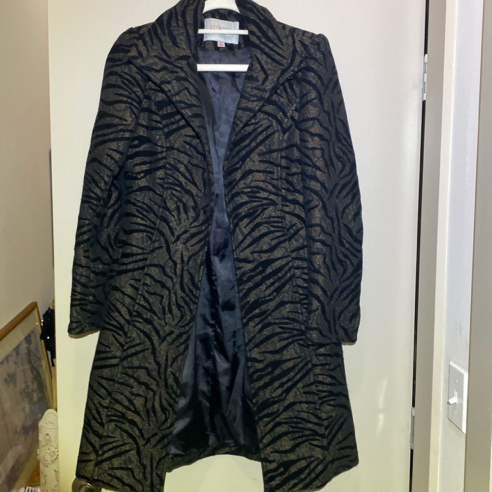 A dressy jacket by Georgiou Studio. Size is a big extra small. In decent shape